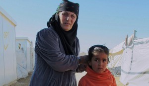 Grandmother Da'ed and her granddaughter Najoua stand in the Za'atari Refugee Camp in Jordan, March 1st, 2015. (photo by Brenda Stoter)